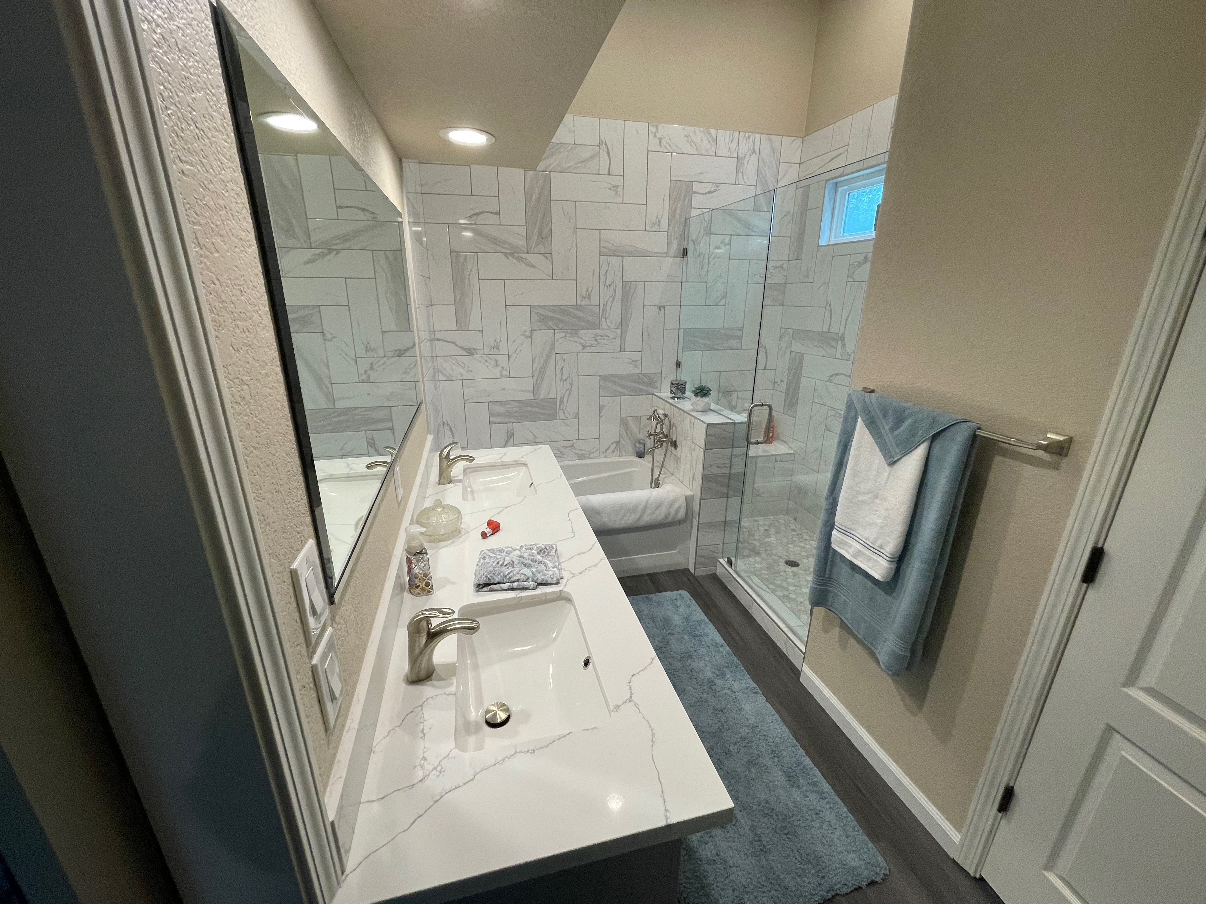 Modern bathroom with quartz vanity and marble shower