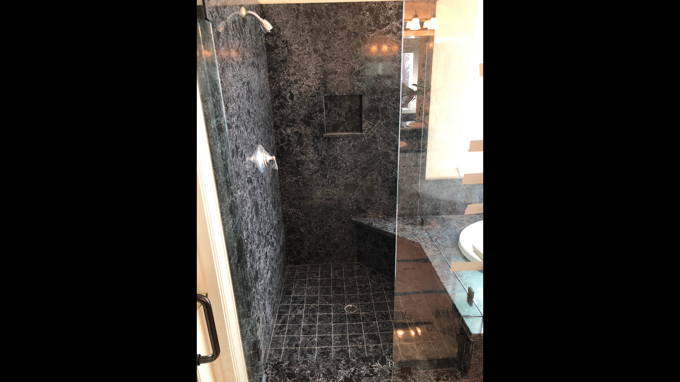 Dark granite full shower surround